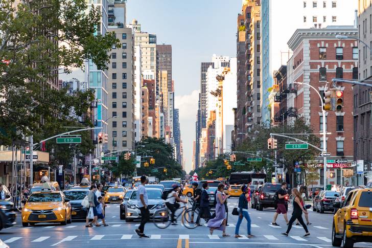 A stock image of cars and pedestrians in Manhattan.